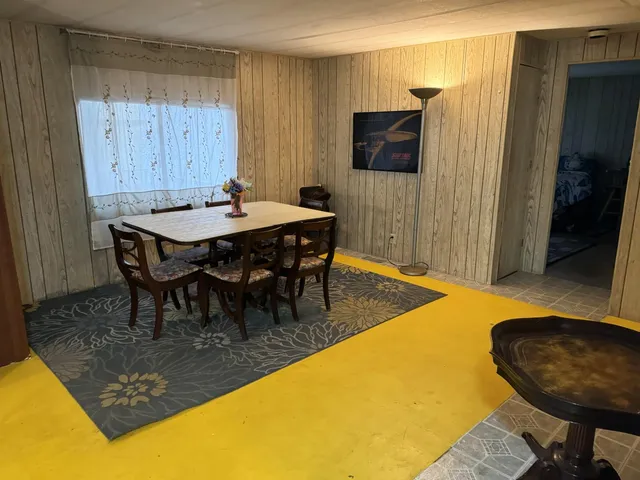 a dining room with furniture and wooden floor