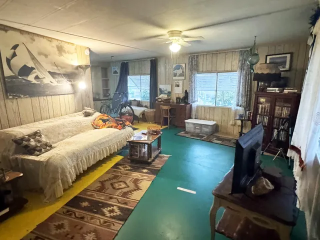 a bed room with a bed furniture and a wooden floor