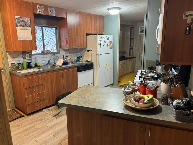 a kitchen with refrigerator and stove