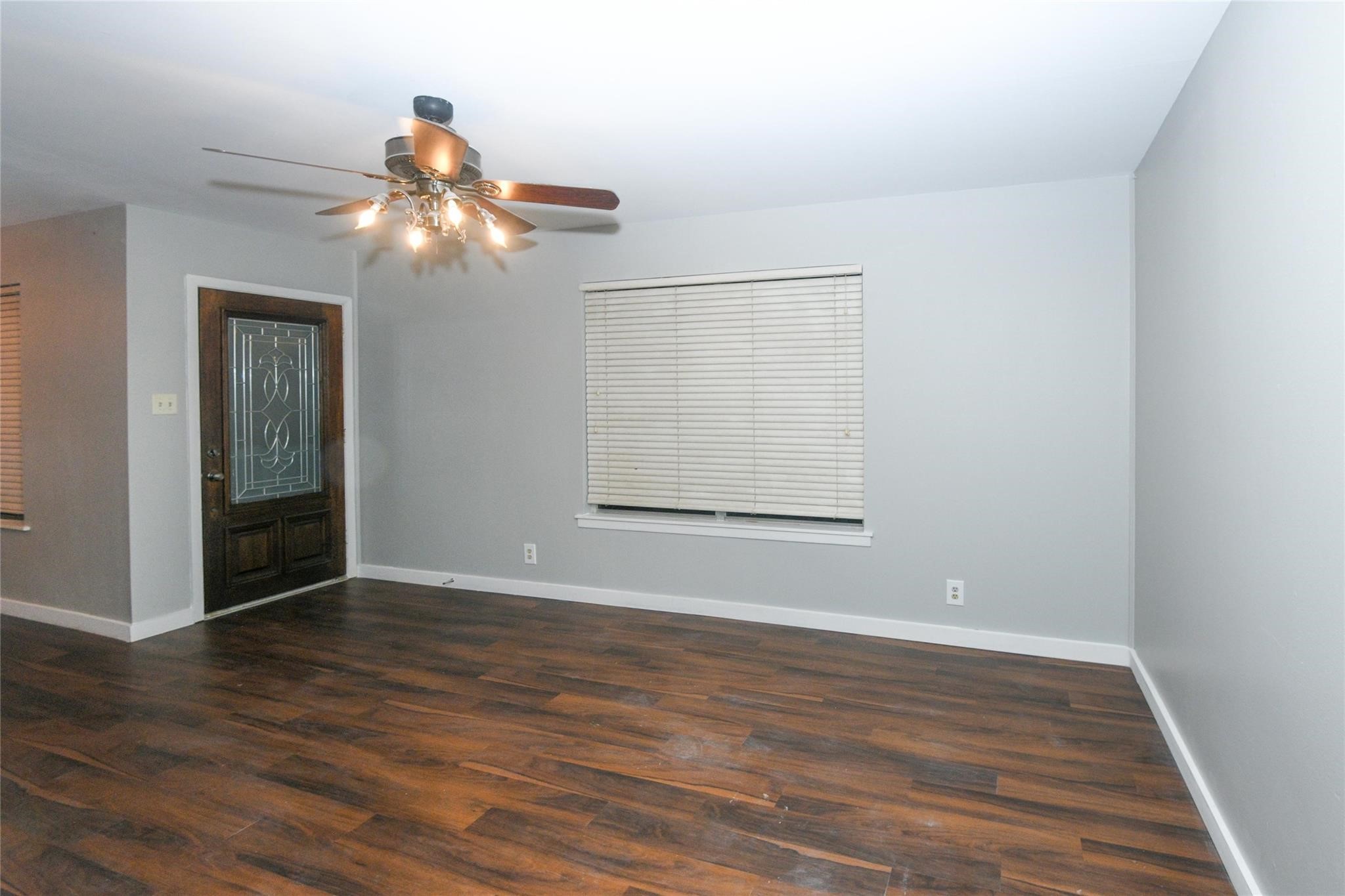204 East 18th Street Georgetown, TX 78626 - Photo 3 of 21 a view of an empty room with wooden floor and a window