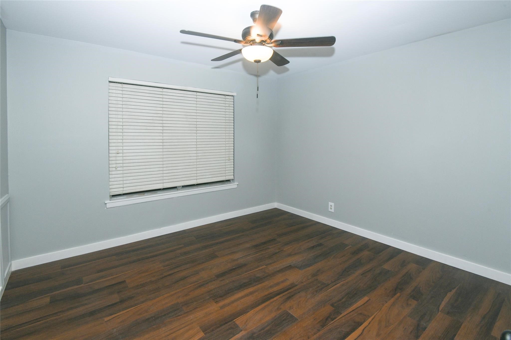 204 East 18th Street Georgetown, TX 78626 - Photo 6 of 21 a view of an empty room with wooden floor and a window