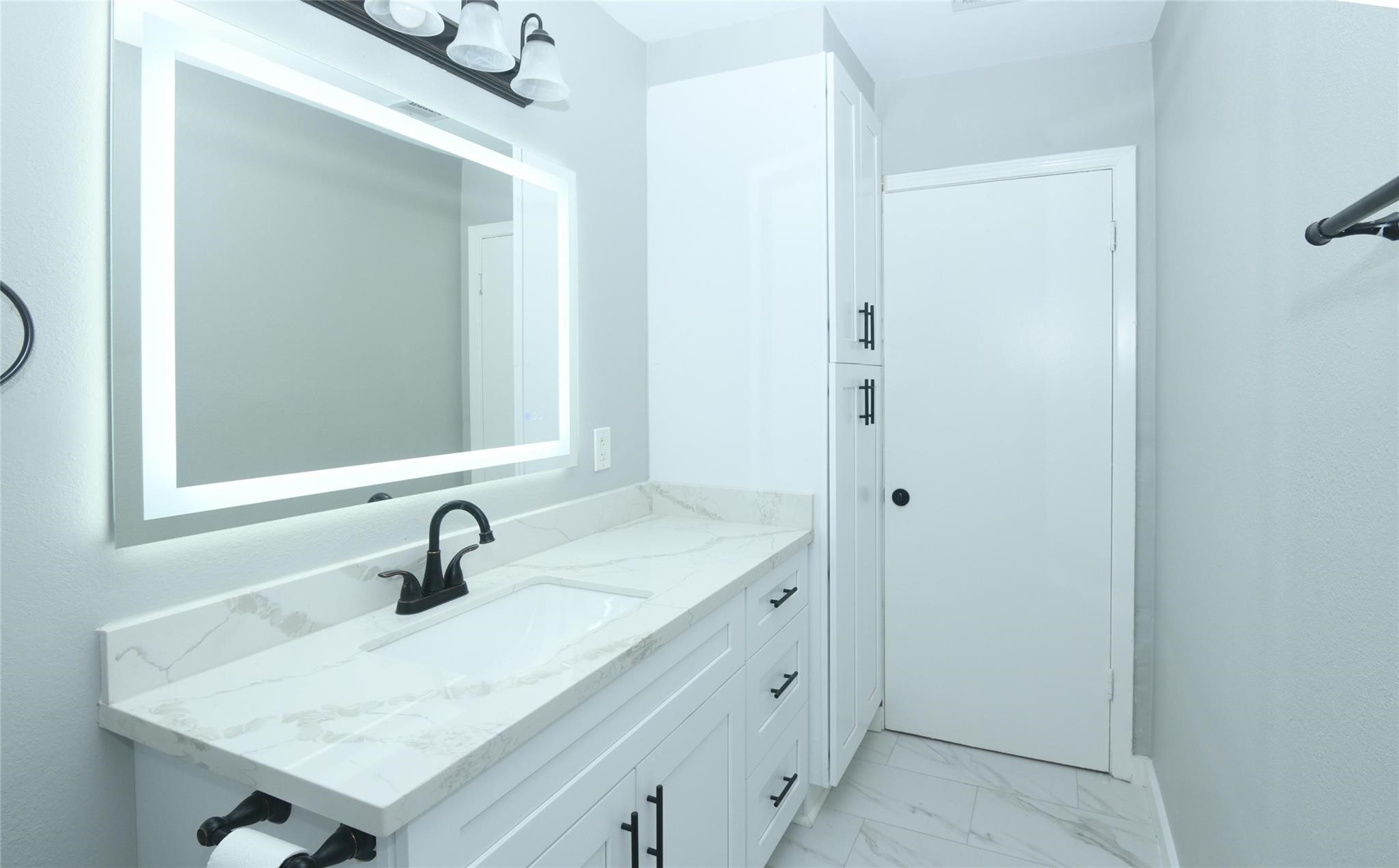 204 East 18th Street Georgetown, TX 78626 - Photo 8 of 21 a bathroom with a sink and a mirror