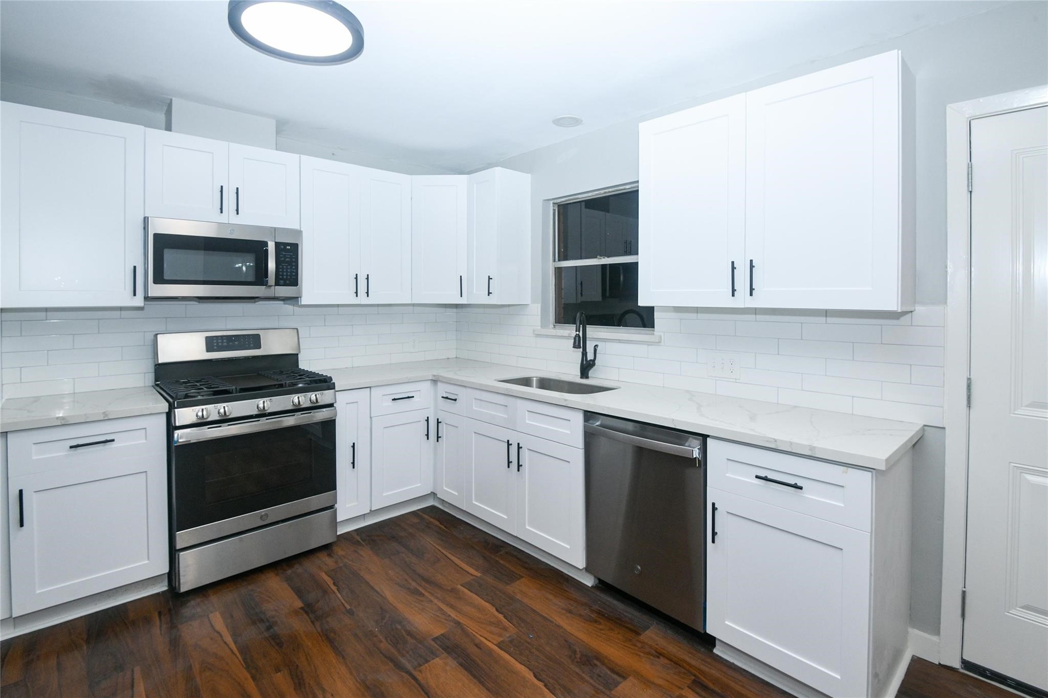 204 East 18th Street Georgetown, TX 78626 - Photo 10 of 21 a kitchen with cabinets stainless steel appliances and sink