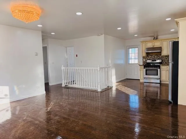 a view of kitchen with stove and wooden floor