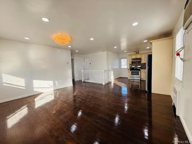 a view of kitchen and a window with wooden floor