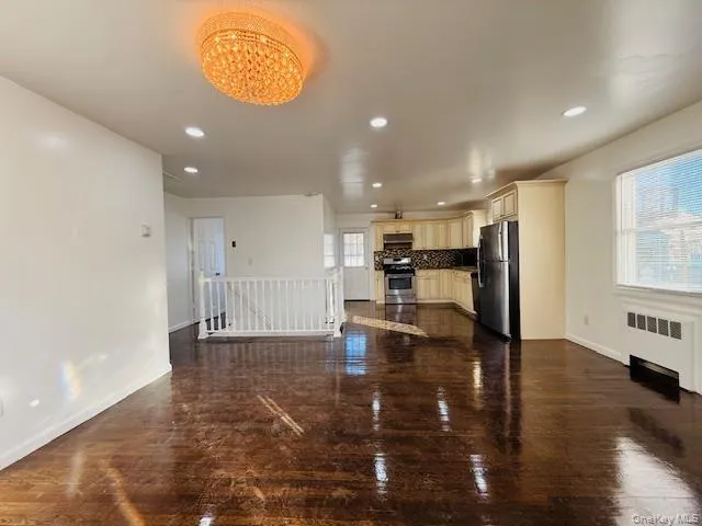 a view of kitchen with furniture and wooden floor
