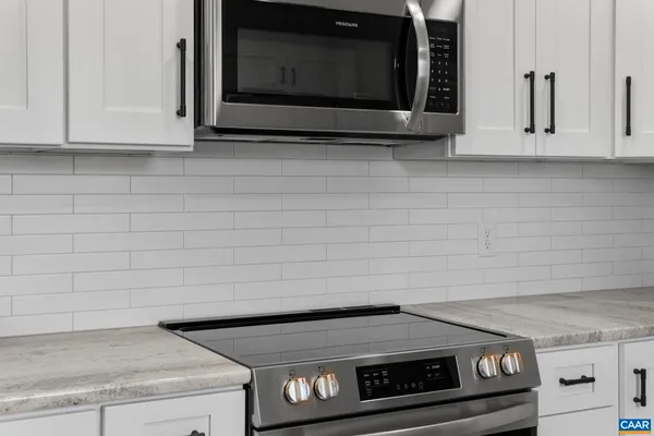 a stove top oven sitting inside of a kitchen