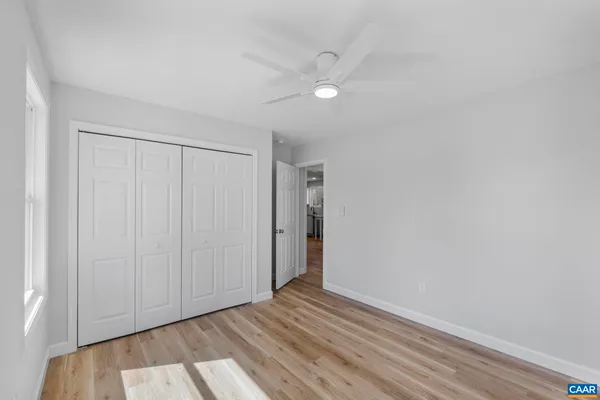 a view of an empty room with wooden floor