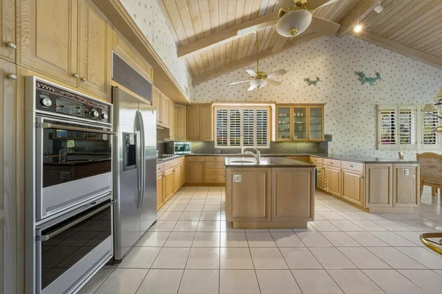 a large kitchen with cabinets and stainless steel appliances