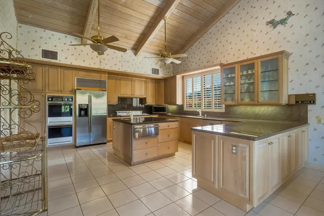 a kitchen with stainless steel appliances granite countertop a stove and cabinets