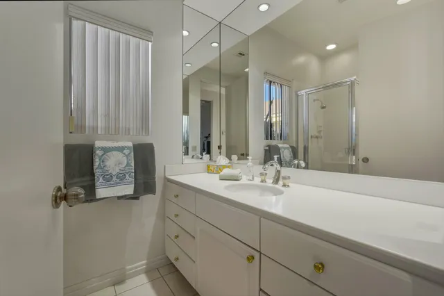 a view of a chairs and table in the patio with swimming pool in the back