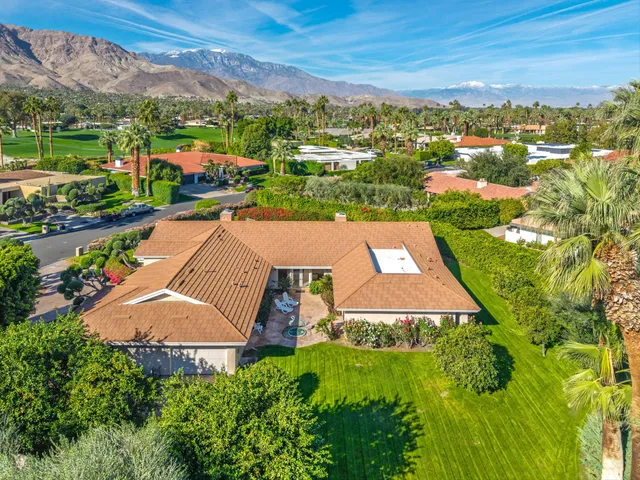 an aerial view of residential houses with outdoor space and street view