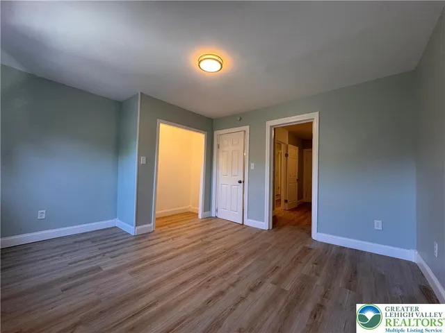 a view of a patio with table and chairs and wooden fence