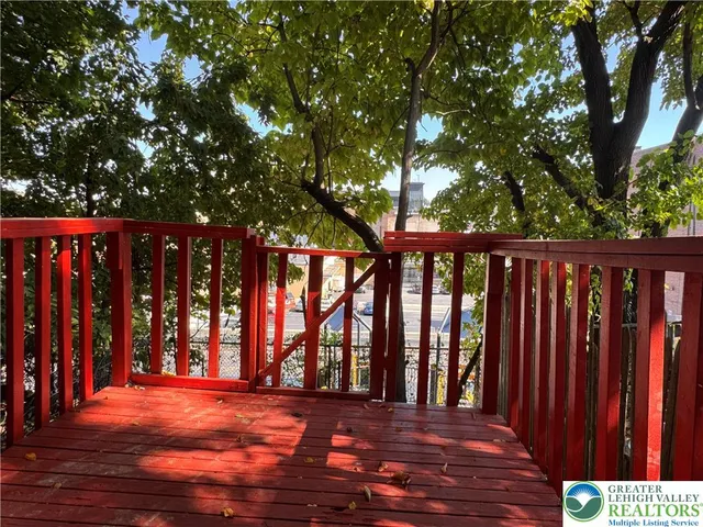 a porch with a table and chairs