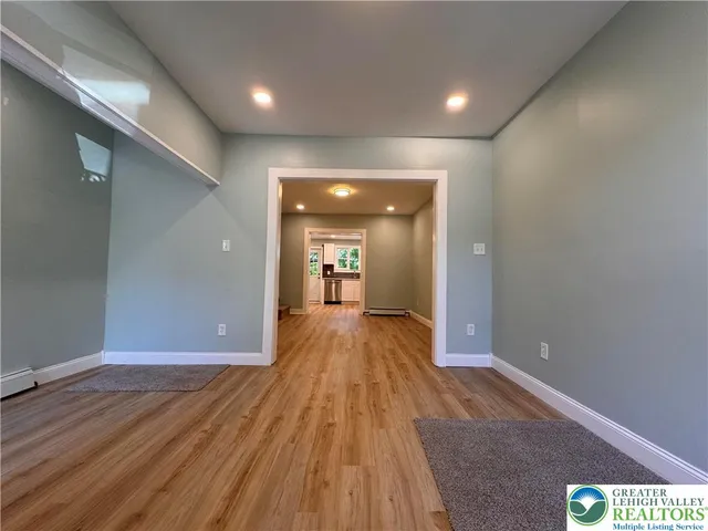 a view of a hallway with wooden floor