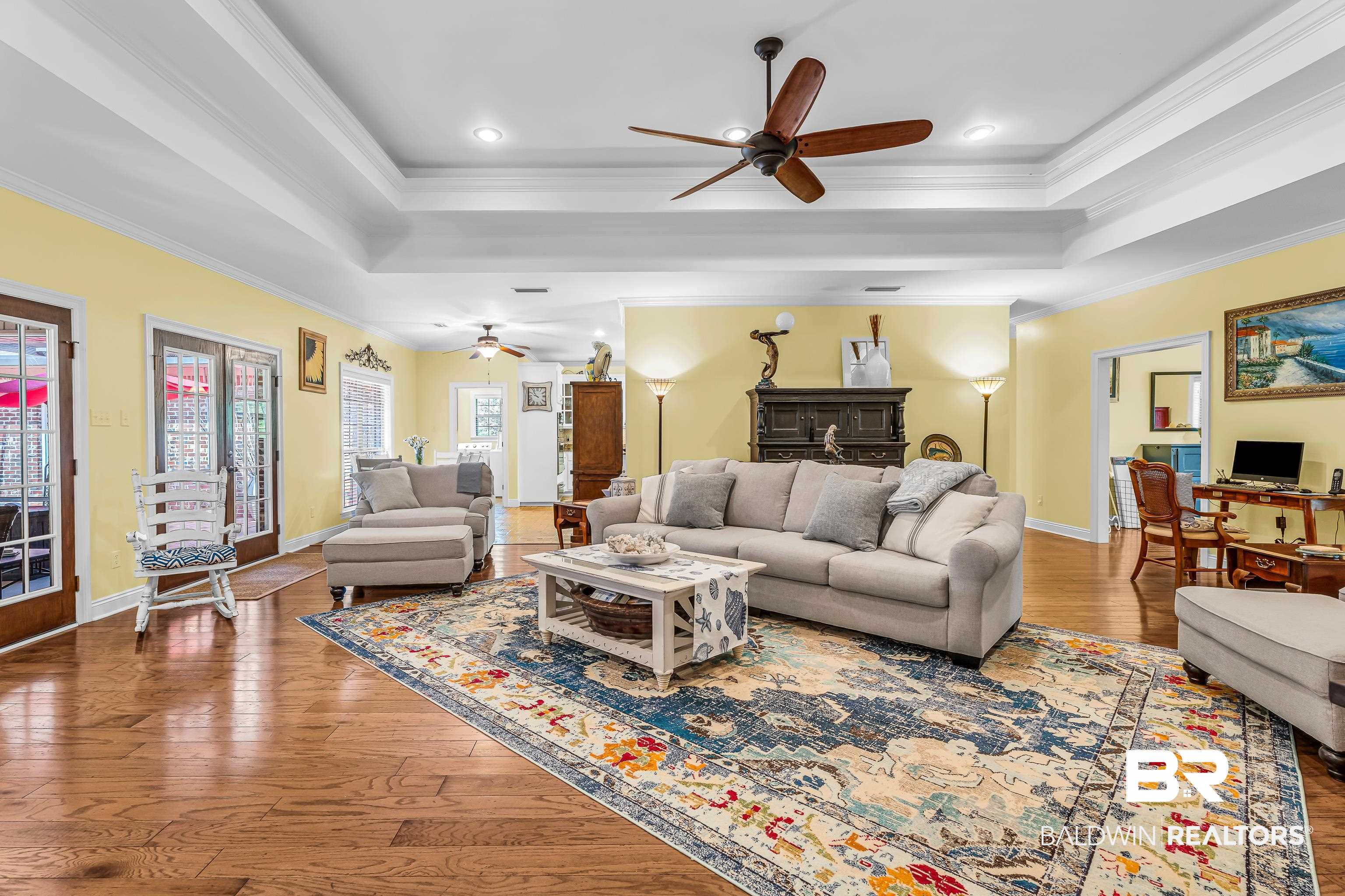 7014 Blakeley Road Daphne, AL 36527 - Photo 25 of 45 Expansive living area featuring coffered ceilings, recessed lighting, and wood-finish flooring