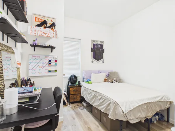 a bedroom with a bed and a table in it