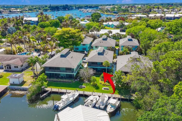 an aerial view of residential houses with outdoor space and swimming pool