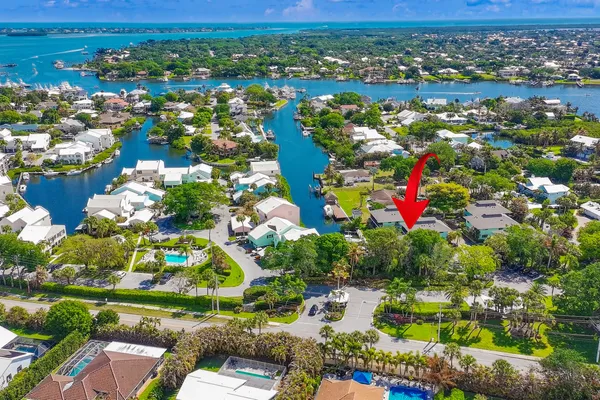 an aerial view of lake and residential houses with outdoor space