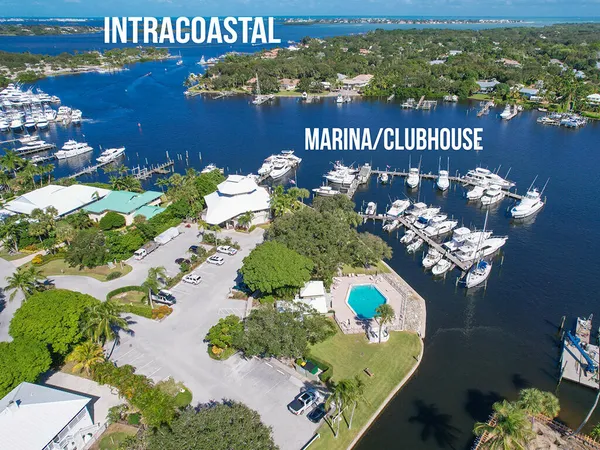 an aerial view of a house with table chairs and a swimming pool