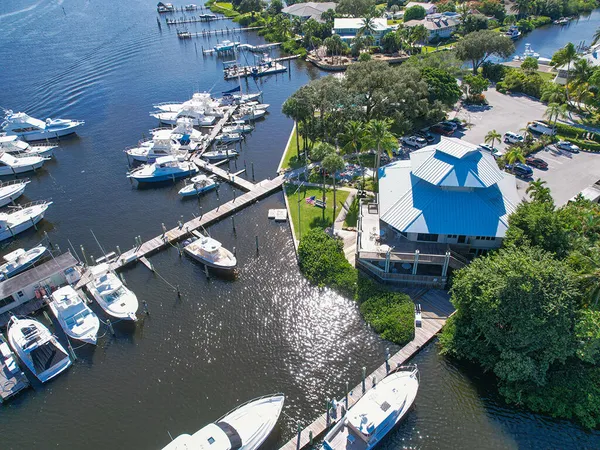 an aerial view of a house with a yard and lake view