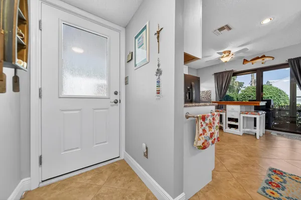 a kitchen with kitchen island a refrigerator stove and sink