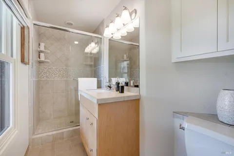 a bathroom with a sink a toilet and shower
