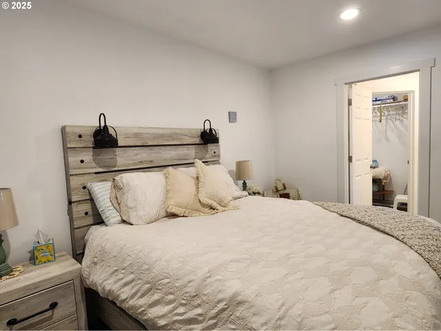 a bedroom with a bed and a potted plant