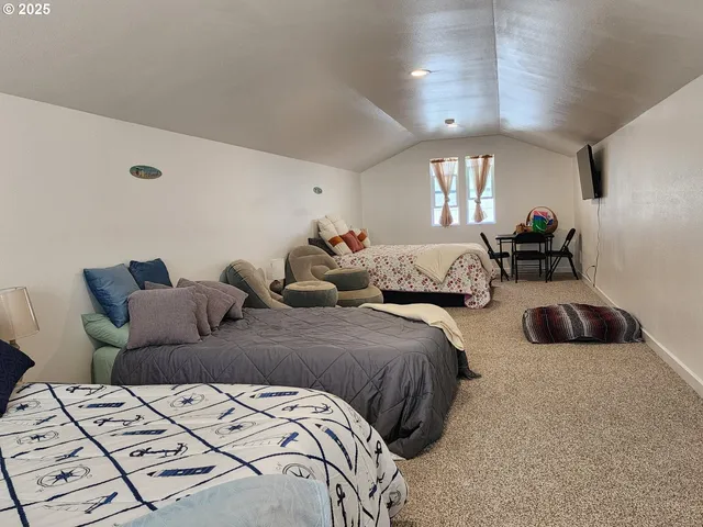 a bed room with two bed and a large mirror