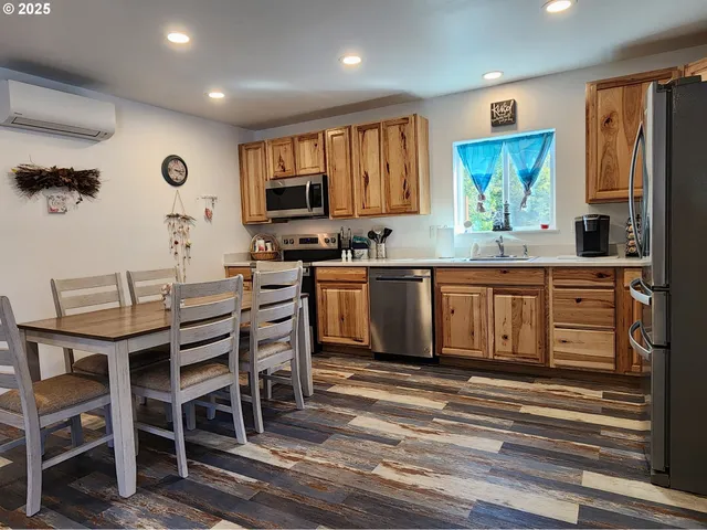 a large kitchen with cabinets table and chairs