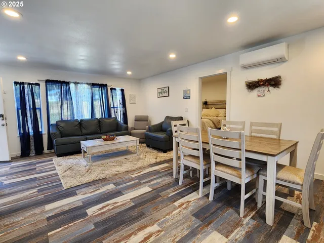 a living room with furniture a ceiling fan and a rug