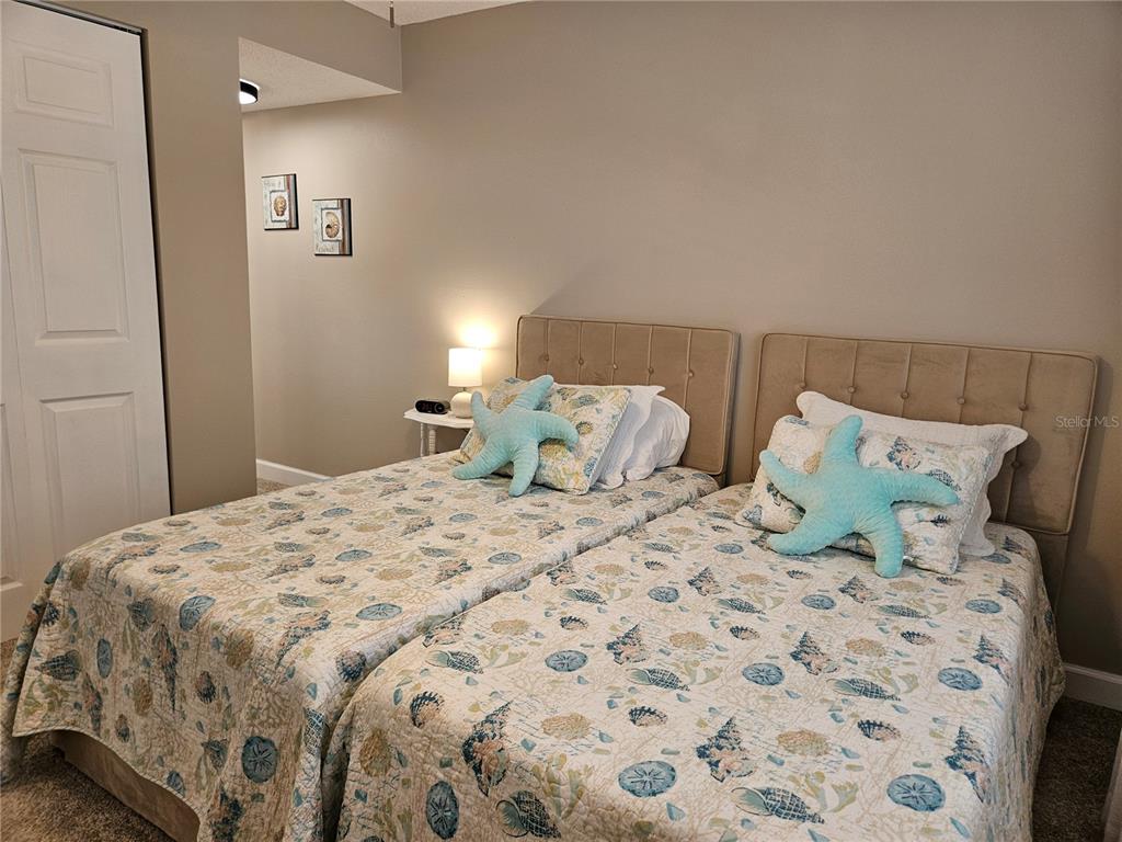 519 Albee Farm Road, Unit 114 Venice, FL 34285 - Photo 18 of 21 a large bed sitting in a bedroom next to a bathroom