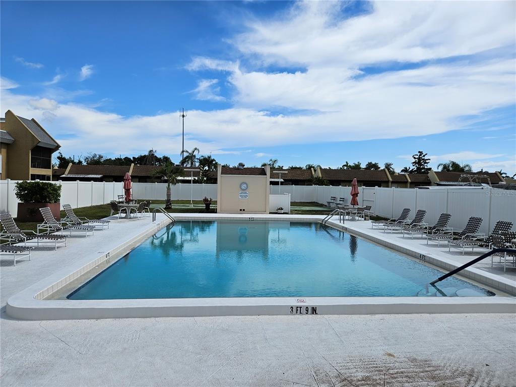 519 Albee Farm Road, Unit 114 Venice, FL 34285 - Photo 21 of 21 a view of a swimming pool with a table and chairs