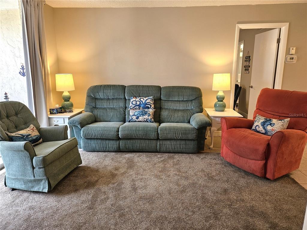 519 Albee Farm Road, Unit 114 Venice, FL 34285 - Photo 6 of 21 a living room with furniture and a large window