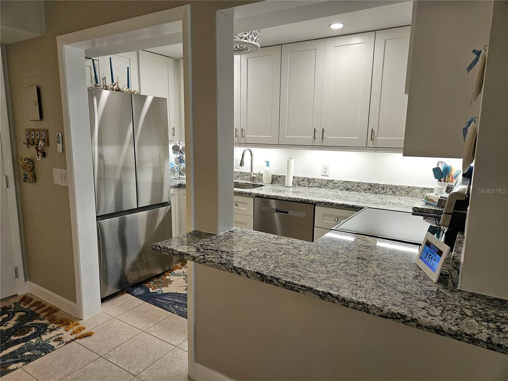 519 Albee Farm Road, Unit 114 Venice, FL 34285 - Photo 10 of 21 a kitchen with stainless steel appliances granite countertop a refrigerator and a sink