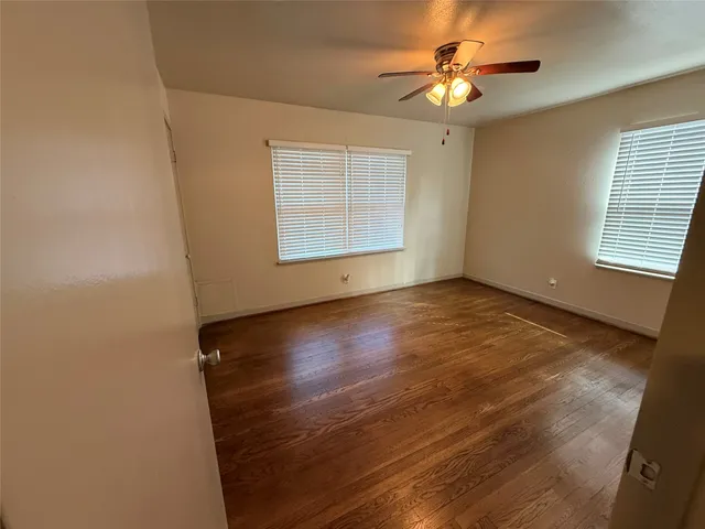 a view of room with window and hardwood floor