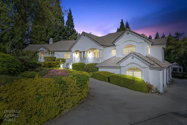 a front view of a house with a garden