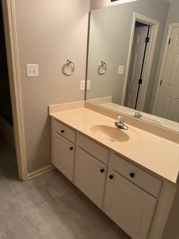 a bathroom with a double vanity sink and mirror