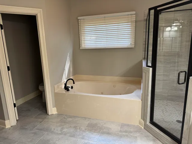 a bathroom with a bathtub and a shower
