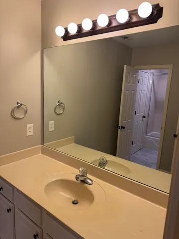 a bathroom with a sink and mirror