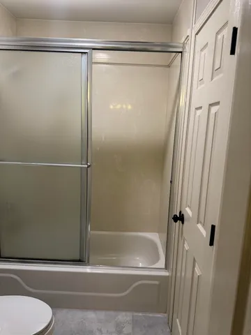 a bathroom with a shower and a toilet