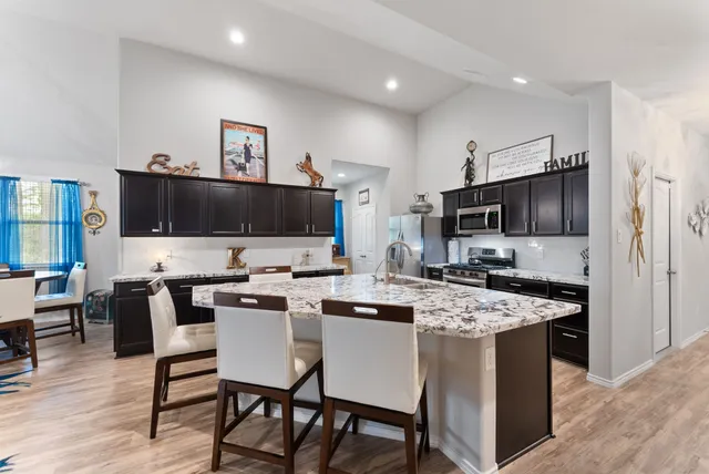 a kitchen that has a table and chairs in it