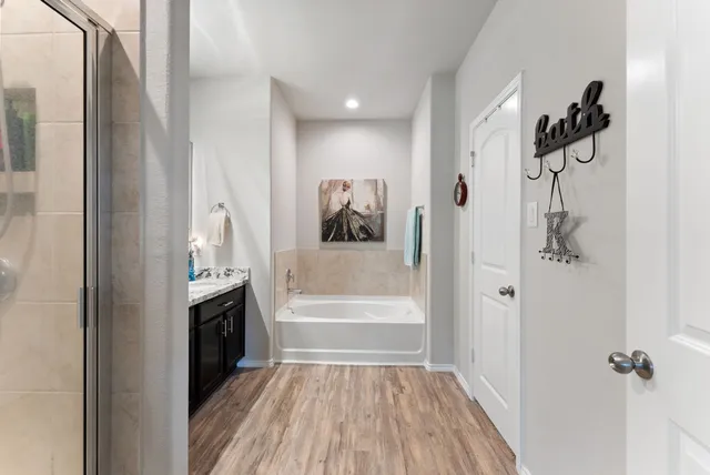 a bathroom with a bathtub and a shower