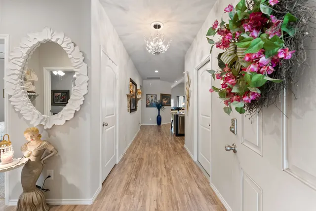 a hallway with beautiful flowers and wooden floor