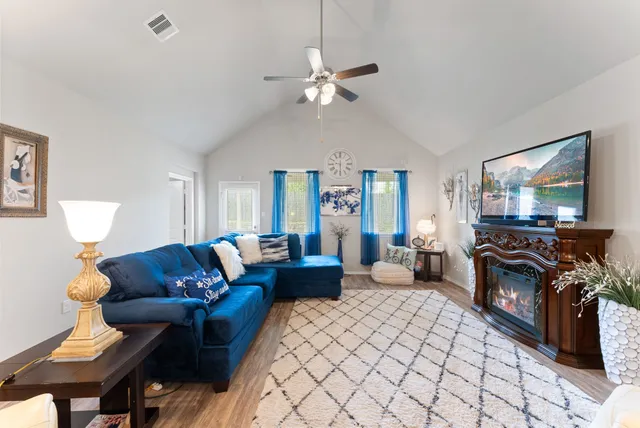 a living room with furniture and a flat screen tv