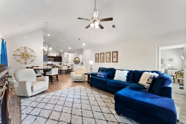 a living room with furniture and a chandelier