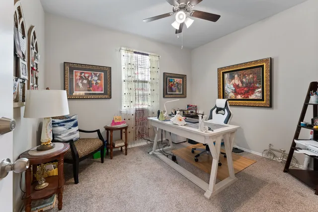 a view of a livingroom with furniture and a workspace