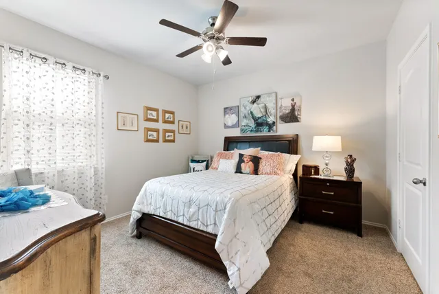 a bedroom with a bed and a table