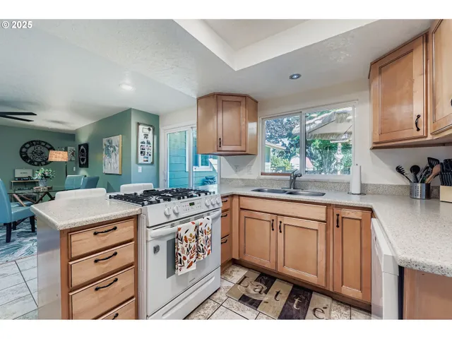 a kitchen that has a lot of cabinets in it and wooden floors