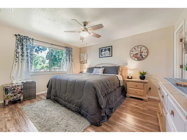 a spacious bedroom with a large bed and a chandelier